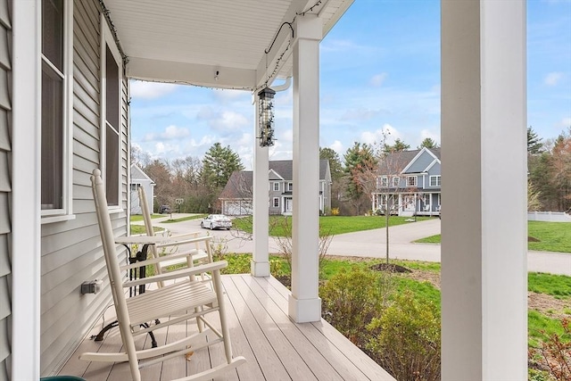 wooden terrace with covered porch and a residential view