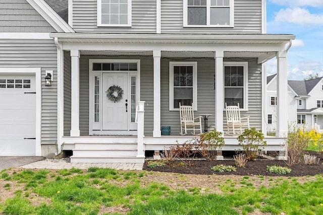 property entrance featuring a garage and covered porch