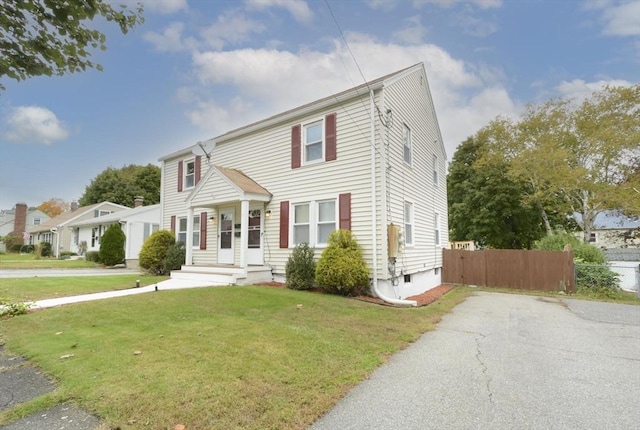 colonial home with a front yard