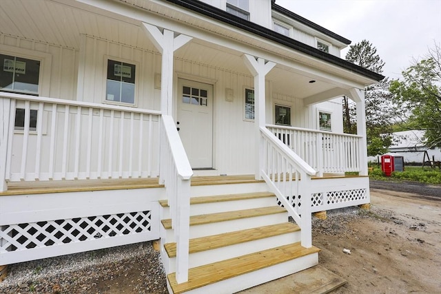 38 Hemlock St, Douglas, MA 01516 - view of exterior entry featuring covered porch and board and batten siding