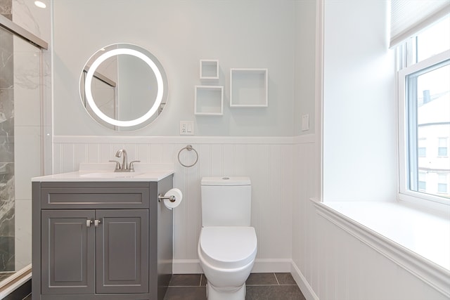 bathroom featuring tile patterned floors, vanity, and toilet