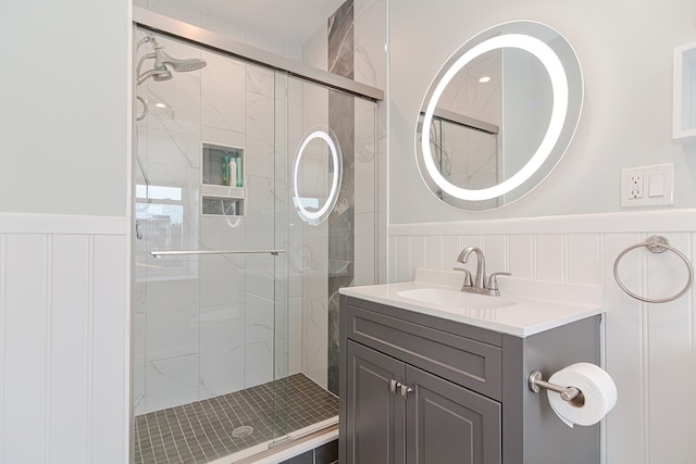 bathroom with vanity, walk in shower, and tasteful backsplash