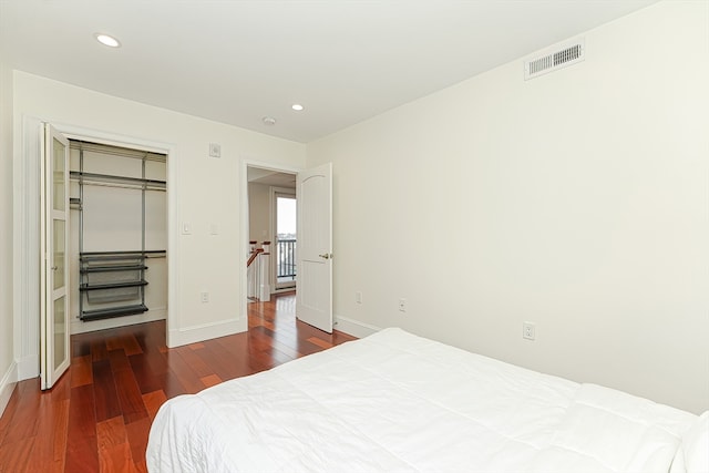 bedroom featuring a closet and dark wood-type flooring