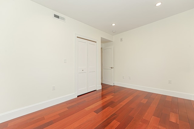 unfurnished room with hardwood / wood-style flooring