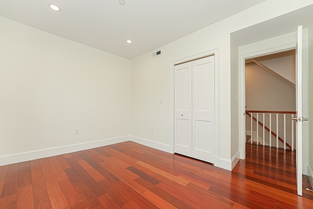 unfurnished bedroom with a closet and wood-type flooring