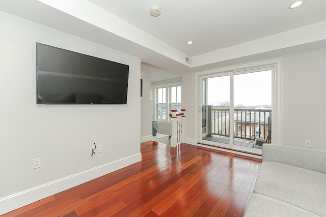 unfurnished living room with wood-type flooring