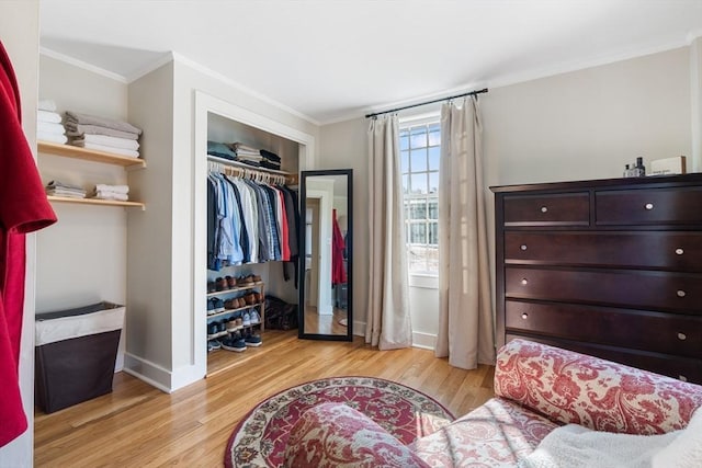 bedroom featuring a closet, ornamental molding, and light hardwood / wood-style floors