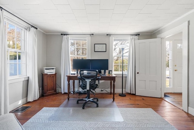 office area with hardwood / wood-style flooring and ornamental molding