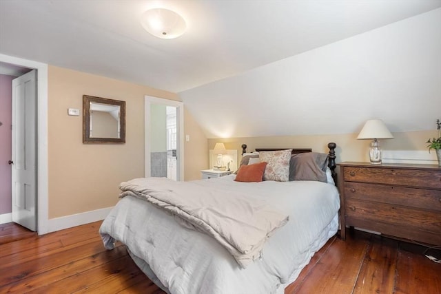 bedroom with lofted ceiling and dark hardwood / wood-style flooring