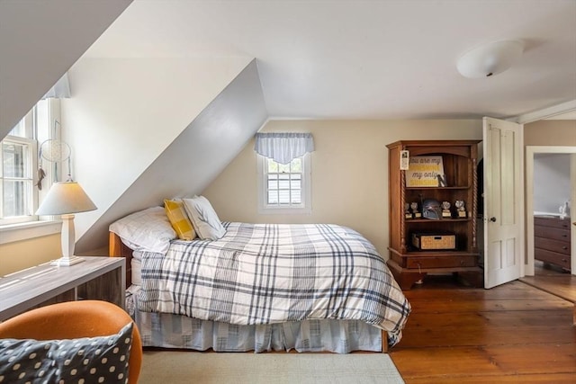 bedroom featuring wood-type flooring and vaulted ceiling