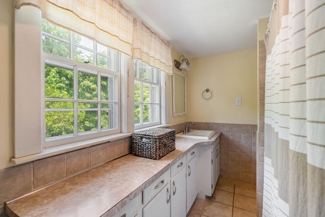 bathroom featuring tile walls, vanity, tile patterned flooring, and a shower with curtain