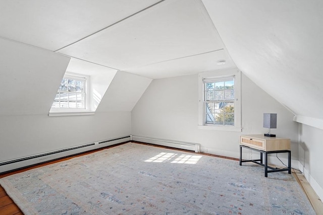 additional living space featuring hardwood / wood-style floors, lofted ceiling, and a wealth of natural light