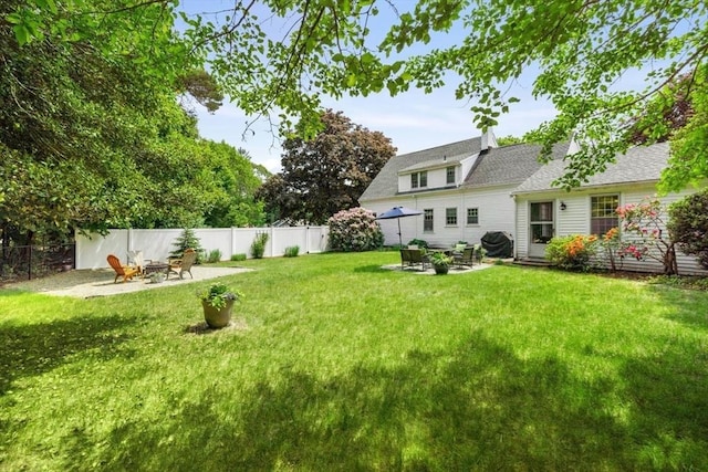 view of yard featuring a patio area and an outdoor fire pit