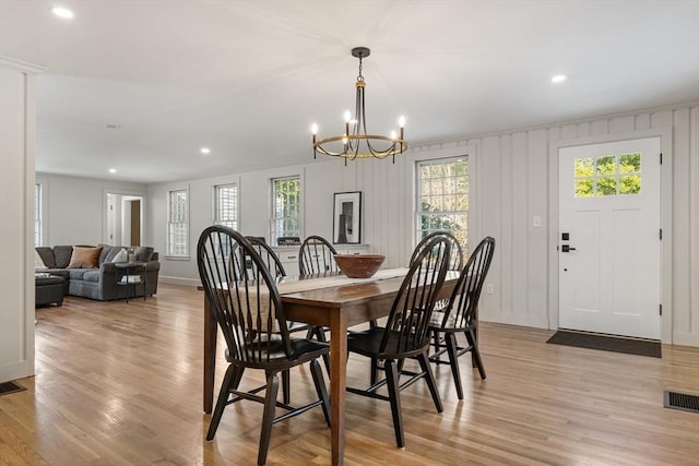 dining area featuring an inviting chandelier and light wood-type flooring