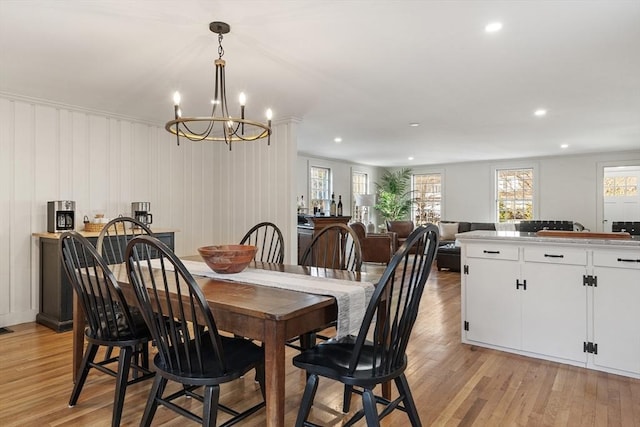 dining area featuring an inviting chandelier and light wood-type flooring