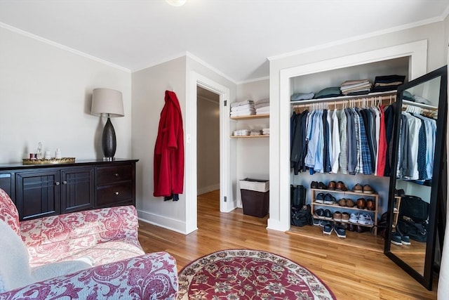 bedroom with crown molding, hardwood / wood-style floors, and a closet