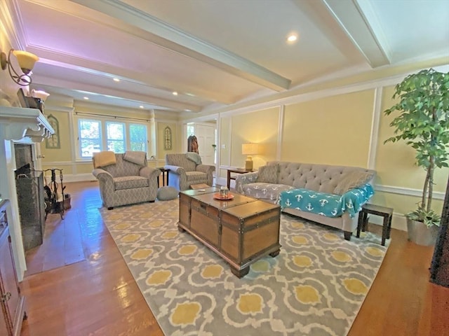 living room with beam ceiling, wood finished floors, a fireplace, and recessed lighting