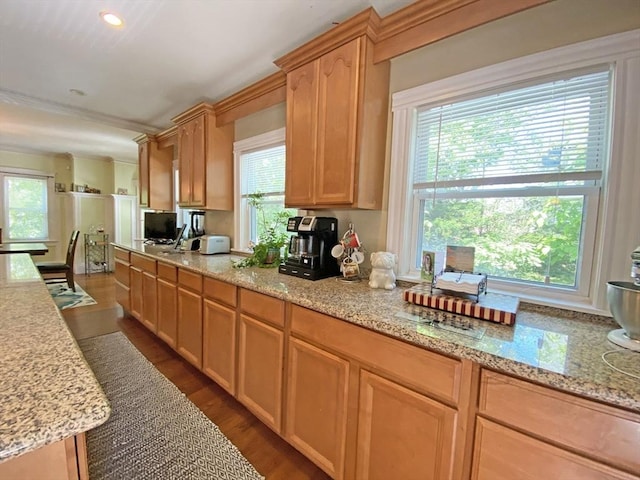 kitchen with dark wood-style floors, light stone countertops, light brown cabinetry, and recessed lighting