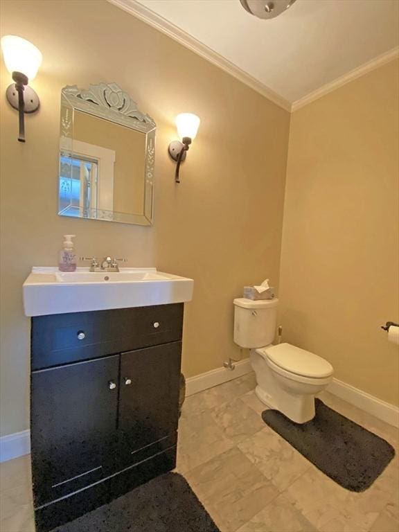 bathroom featuring crown molding, baseboards, toilet, and vanity