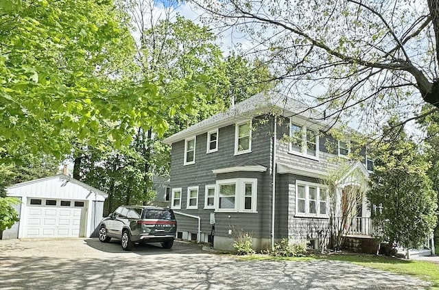 view of home's exterior featuring an outdoor structure, driveway, and a garage