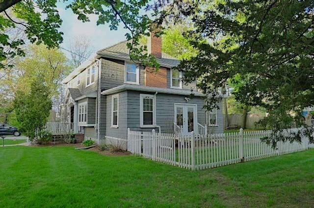 rear view of property with a chimney and french doors