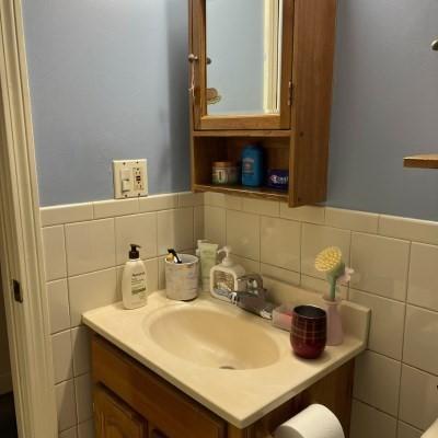 bathroom with vanity and tile walls