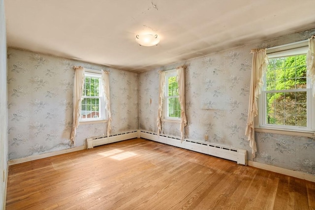 35 Chapin Rd, Holden, MA 01520 - spare room with wood finished floors, baseboards, and a baseboard heating unit