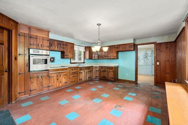 35 Chapin Rd, Holden, MA 01520 - kitchen with oven, brown cabinetry, a chandelier, light countertops, and a sink