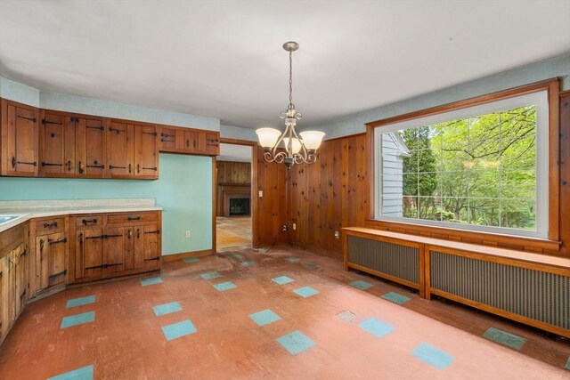 35 Chapin Rd, Holden, MA 01520 - kitchen featuring brown cabinets, radiator, pendant lighting, light countertops, and a chandelier