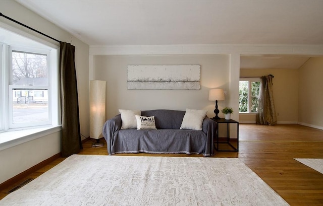 bedroom featuring visible vents, baseboards, and wood finished floors