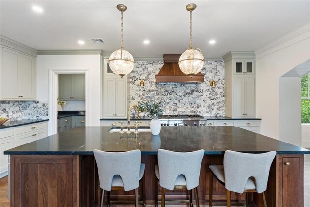 197 Winchester St Unit 197, Brookline, MA 02446 - kitchen featuring dark countertops, premium range hood, decorative backsplash, glass insert cabinets, and recessed lighting