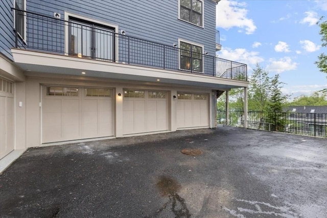 197 Winchester St Unit 197, Brookline, MA 02446 - garage with asphalt driveway and fence