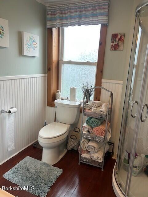 21 River St, North Adams, MA 01247 - full bath with a stall shower, wood-type flooring, a wainscoted wall, and toilet