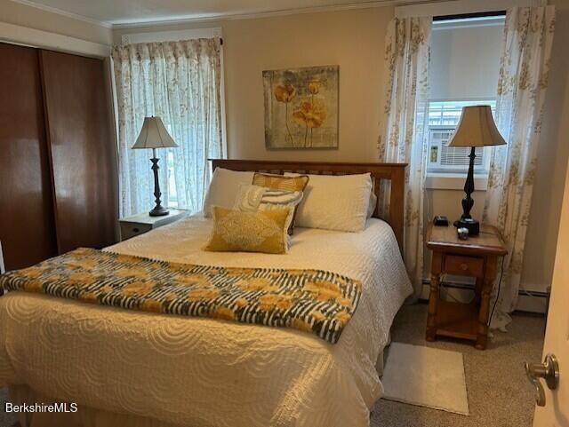 21 River St, North Adams, MA 01247 - bedroom with ornamental molding, a baseboard heating unit, carpet flooring, and a closet