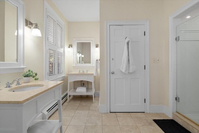 full bath with a sink, tile patterned floors, baseboards, a baseboard radiator, and a stall shower