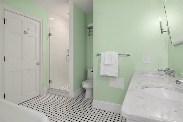 full bath featuring a sink, baseboards, a stall shower, and toilet