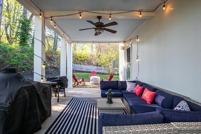 view of patio featuring grilling area, fence, ceiling fan, and outdoor lounge area