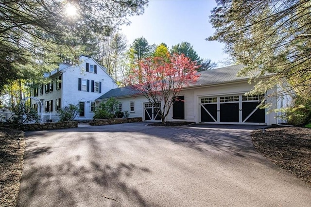 view of front of property with a garage and aphalt driveway
