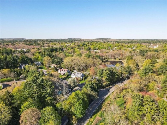birds eye view of property featuring a forest view