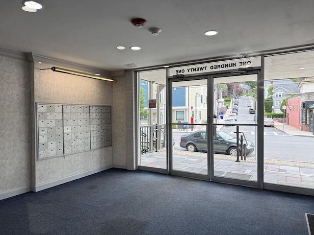 lobby with floor to ceiling windows, recessed lighting, and a security system