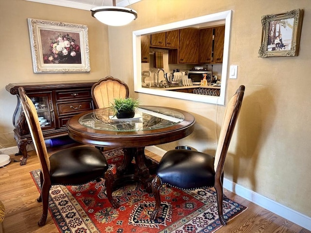 dining area featuring wood finished floors and baseboards