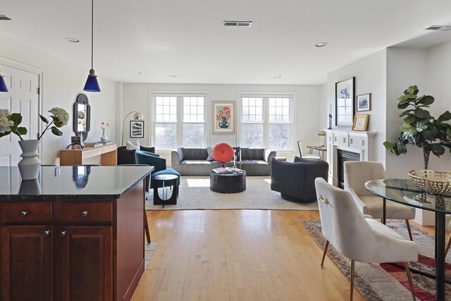 1306 Columbia Rd Unit 5C, Boston, MA 02127 - living room featuring recessed lighting, a fireplace, visible vents, and light wood-type flooring