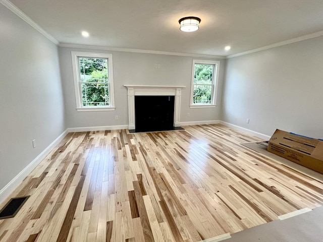 unfurnished living room featuring light wood-style flooring, crown molding, baseboards, a fireplace with flush hearth, and recessed lighting