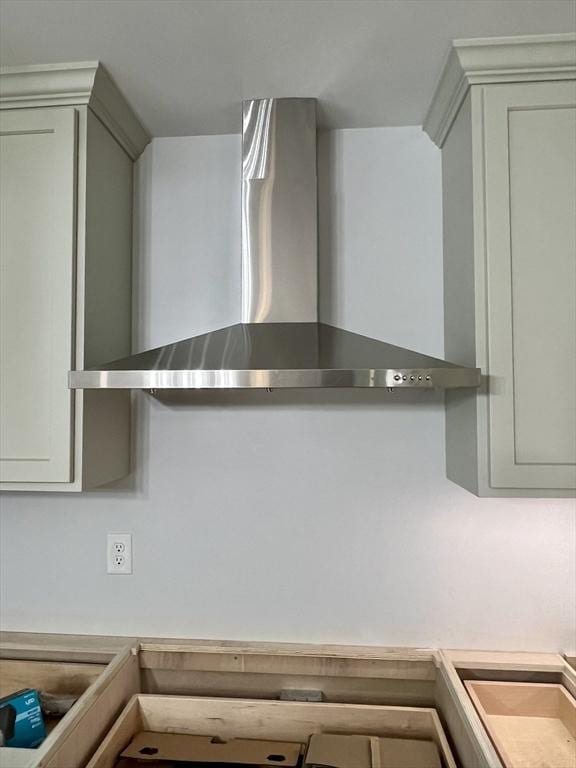 kitchen view of wall chimney range hood and light countertops