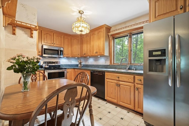 2 Rich Rd, Holliston, MA 01746 - kitchen with stainless steel appliances, dark countertops, a chandelier, pendant lighting, and light floors