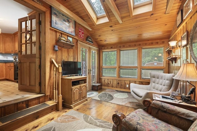 2 Rich Rd, Holliston, MA 01746 - living area with wood ceiling, light wood-style flooring, vaulted ceiling, a skylight, and wood walls