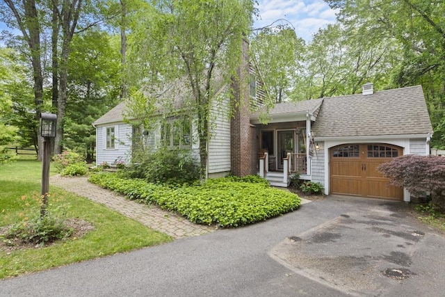 2 Rich Rd, Holliston, MA 01746 - view of front of home featuring an attached garage, driveway, a chimney, and a shingled roof