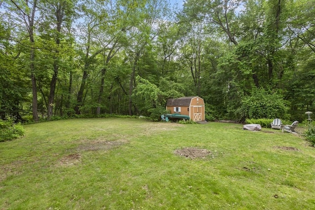 2 Rich Rd, Holliston, MA 01746 - view of green lawn featuring a storage unit and a forest view