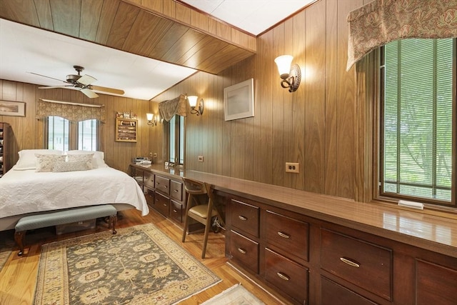 2 Rich Rd, Holliston, MA 01746 - bedroom with multiple windows, built in study area, wood walls, a ceiling fan, and light wood finished floors