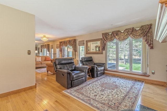 living area with baseboards and light wood-style flooring